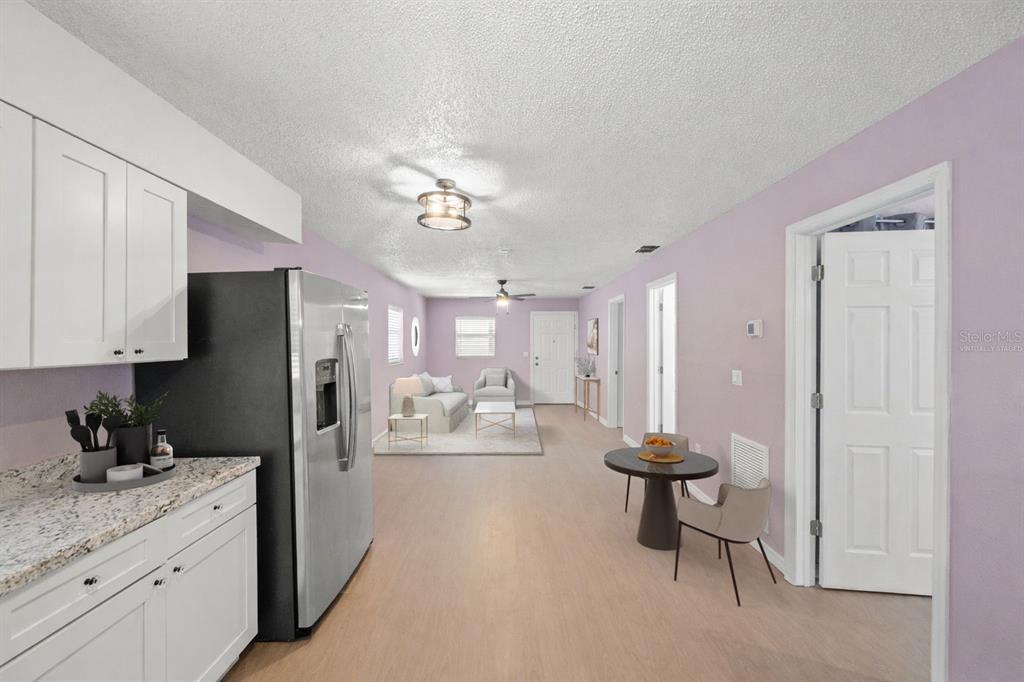 4489 Fishman Avenue Weeki Wachee, FL 34607 - Photo 9 of 29 a kitchen with stainless steel appliances kitchen island granite countertop a refrigerator and a sink