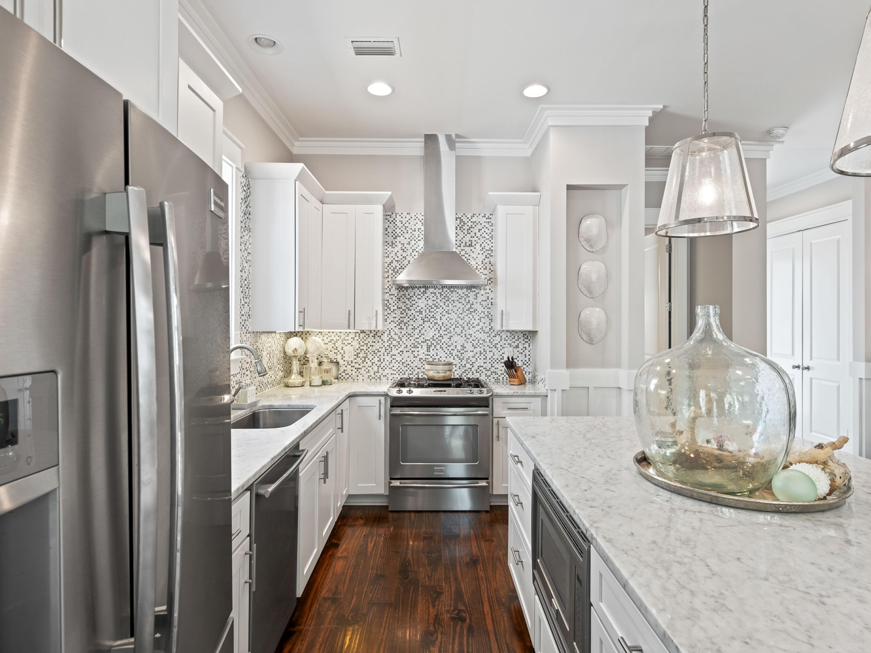 37 Dune Ridge Road Santa Rosa Beach, FL 32459 - Photo 12 of 40 a kitchen with stainless steel appliances granite countertop a sink stove and refrigerator