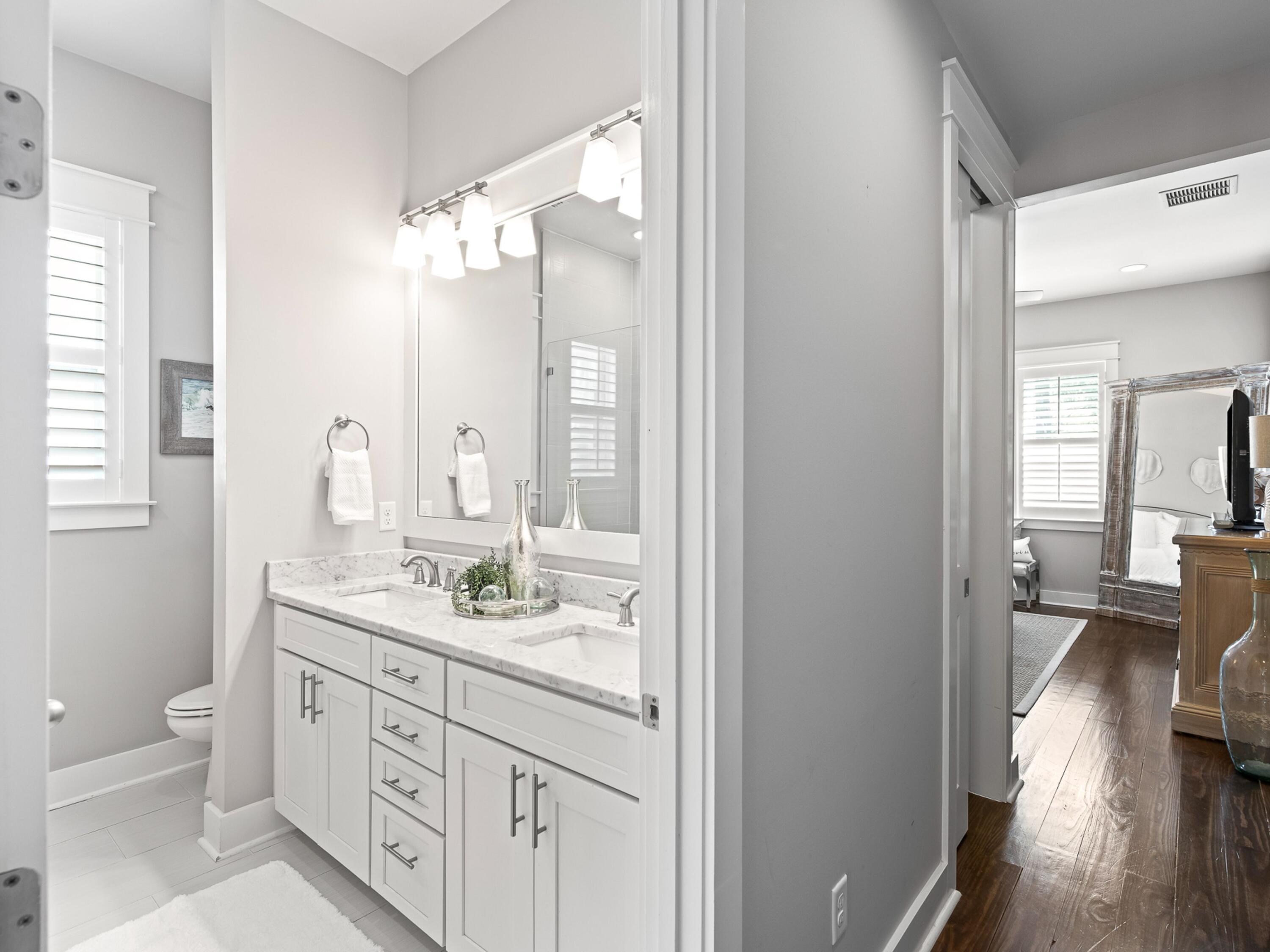 37 Dune Ridge Road Santa Rosa Beach, FL 32459 - Photo 16 of 40 a spacious bathroom with a granite countertop sink mirror and a toilet