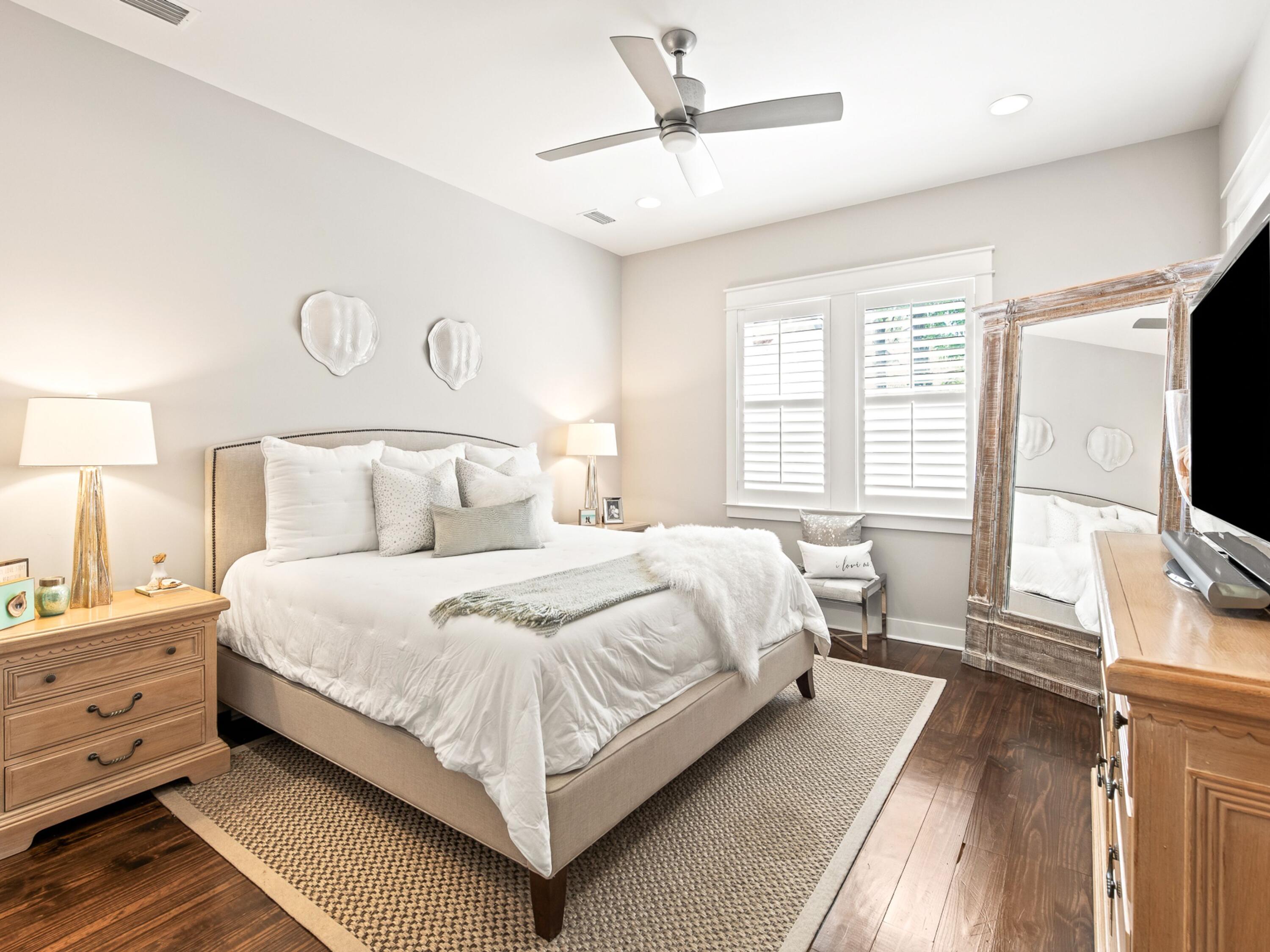 37 Dune Ridge Road Santa Rosa Beach, FL 32459 - Photo 19 of 40 a bedroom with a bed flat screen tv and a large window