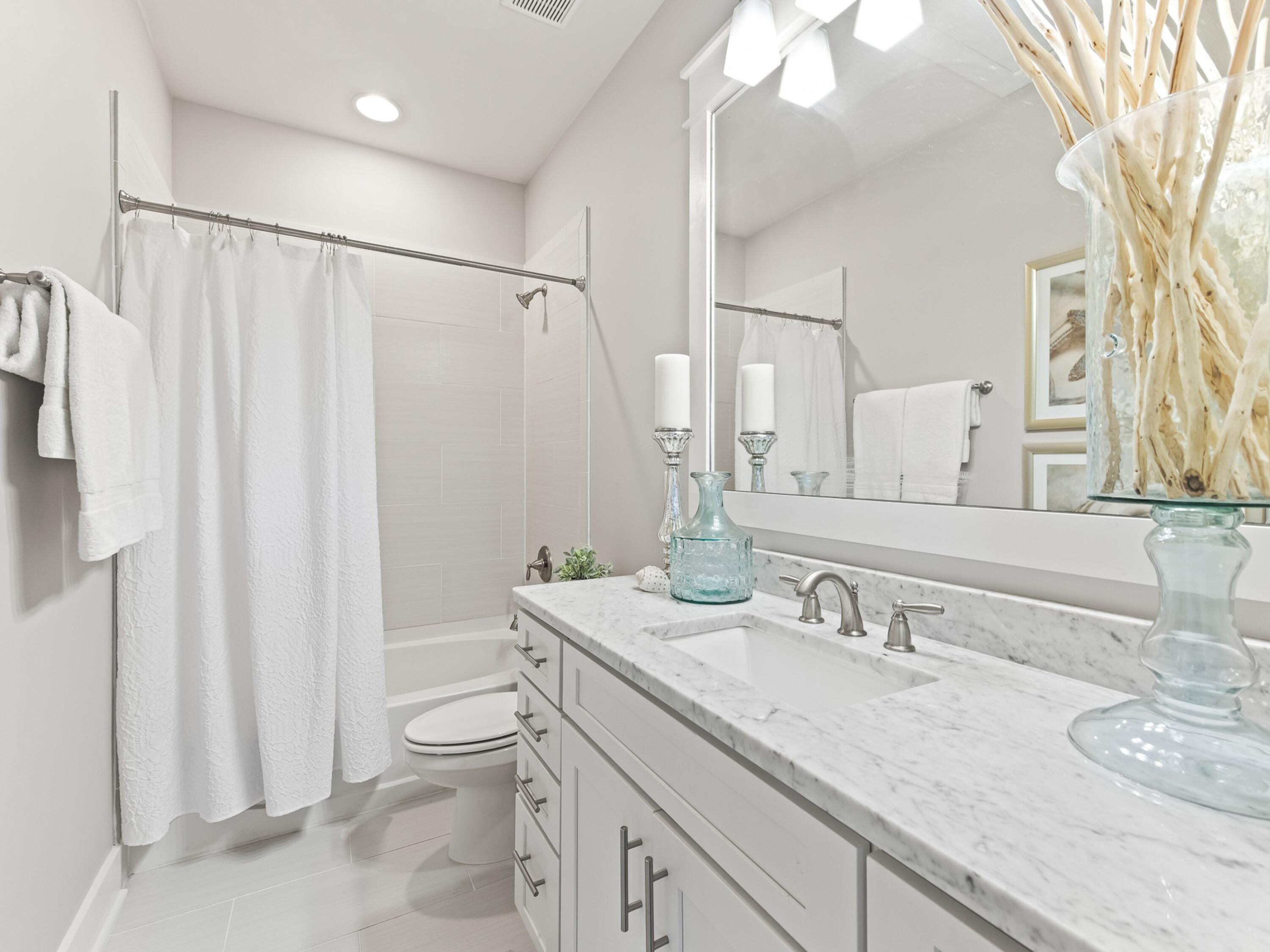 37 Dune Ridge Road Santa Rosa Beach, FL 32459 - Photo 24 of 40 a bathroom with a granite countertop sink a toilet and a mirror