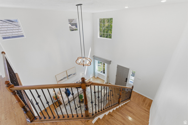 2007 Fielding Hill Lane Draper, UT 84020 - Photo 10 of 83 Two-story foyer featuring a contemporary chandelier, hardwood flooring, and wrought iron balusters