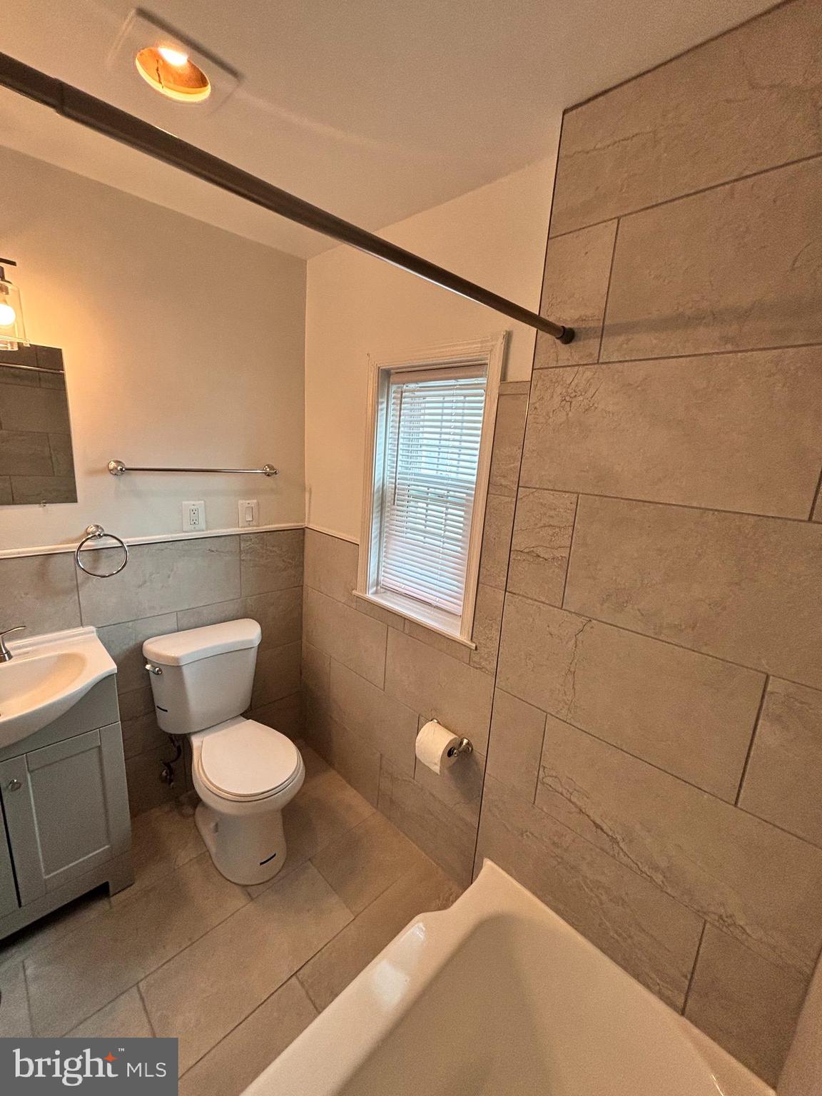 3810 V Street Southeast, Unit 301 Washington, DC 20020 - Photo 14 of 36 a bathroom with a toilet sink and mirror