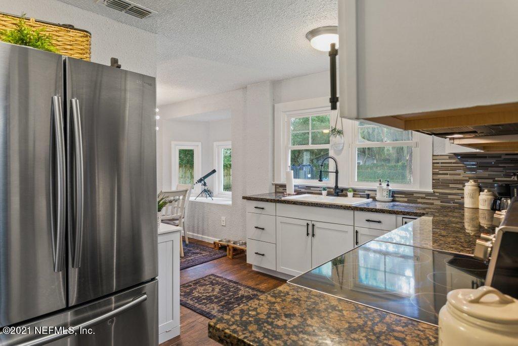 1640 Lakewood Road Jacksonville, FL 32207 - Photo 13 of 37 a kitchen with stainless steel appliances granite countertop a refrigerator and sink