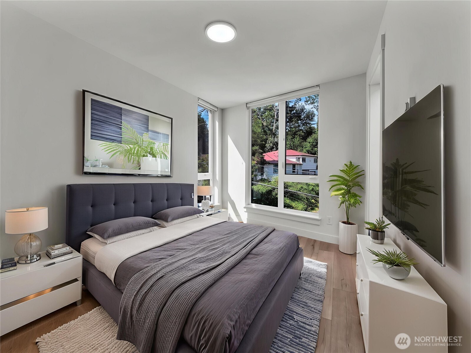 3628 14th Avenue South Seattle, WA 98144 - Photo 16 of 24 a bedroom with a bed and a flat screen tv