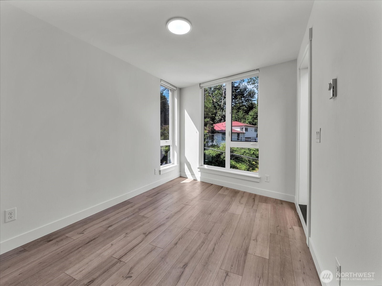 3628 14th Avenue South Seattle, WA 98144 - Photo 17 of 24 a view of an empty room with wooden floor and a window