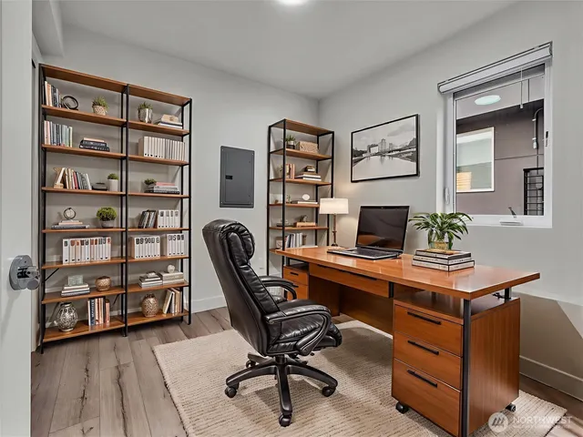 a view of a workspace with a bookshelf and a workspace