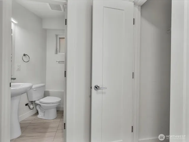 a white toilet sitting next to a bathroom sink
