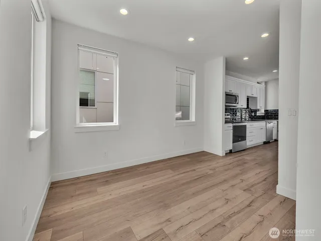 a view of kitchen with wooden floor and electronic appliances