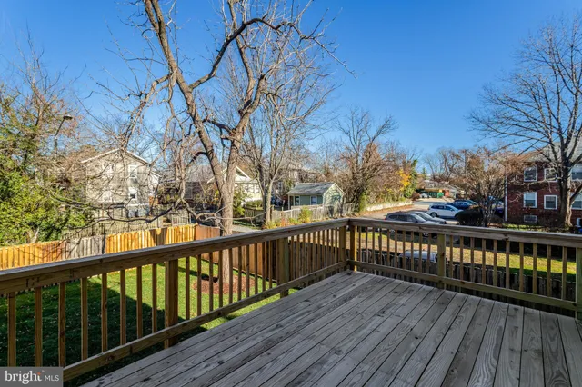 a view of balcony with wooden floor and fence