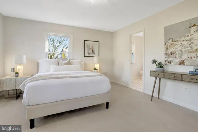 a bathroom with a toilet a window and shower