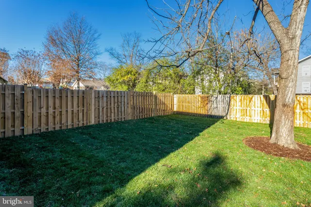 front view of a brick house with a yard