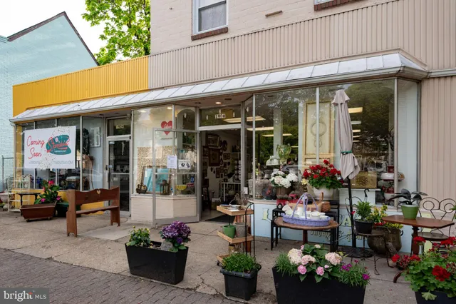 a front view of a house with yard and sitting area