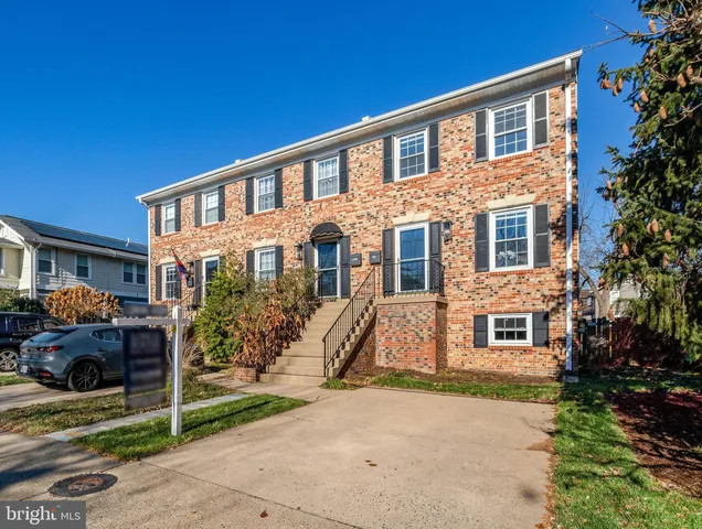 a living room with furniture and a dining table with wooden floor