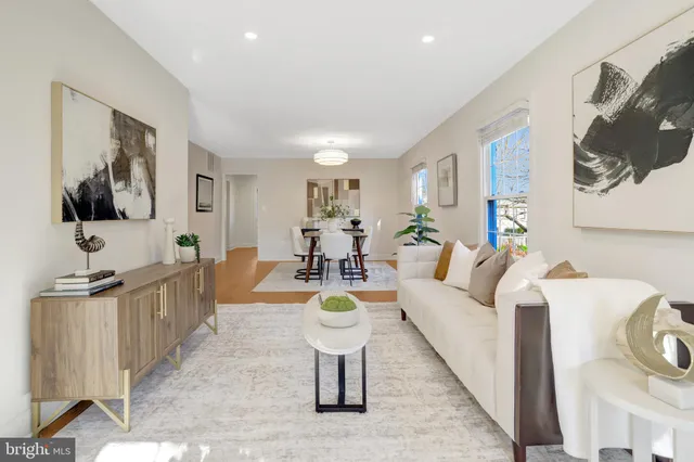 a living room with furniture a couch and a window