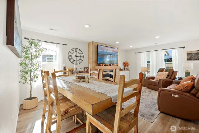 a view of a dining room with furniture and a large window