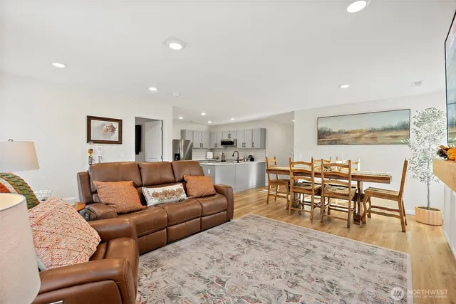 a living room with furniture a dining table and kitchen view