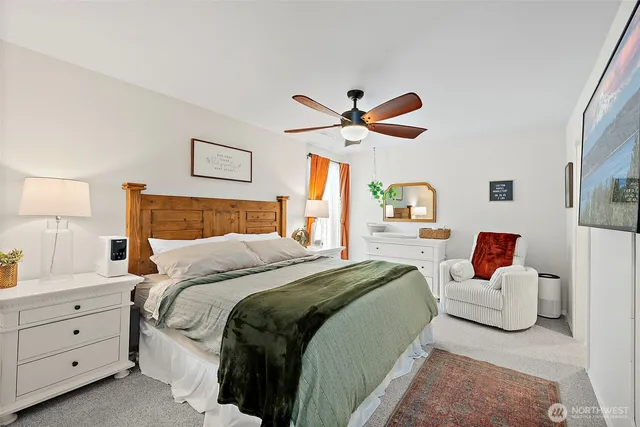 a bedroom with a large bed and a chandelier