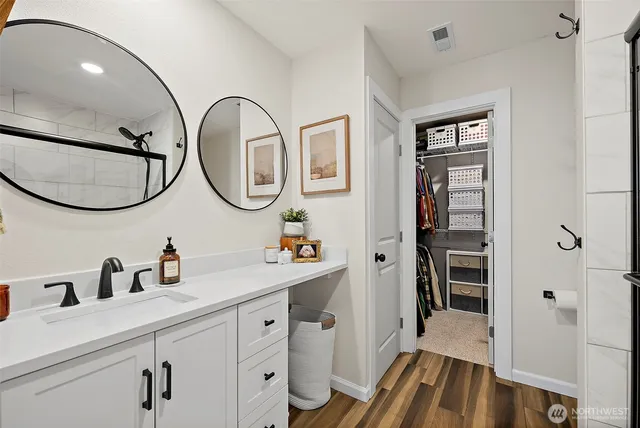 a bathroom with a sink a mirror and a shower