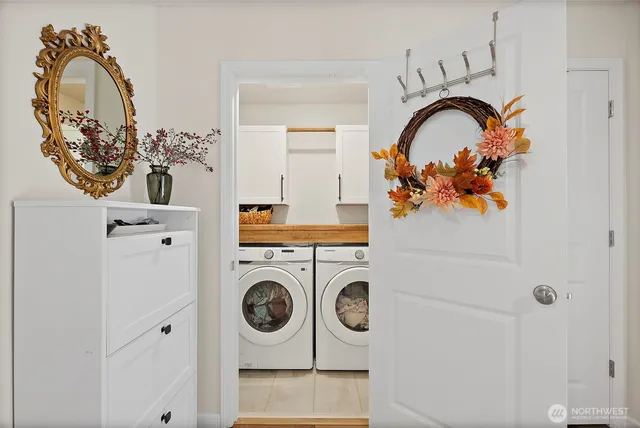 a close view of a utility room with dryer and washer