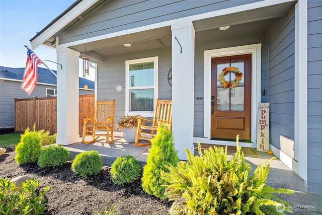 a front view of a house with outdoor seating