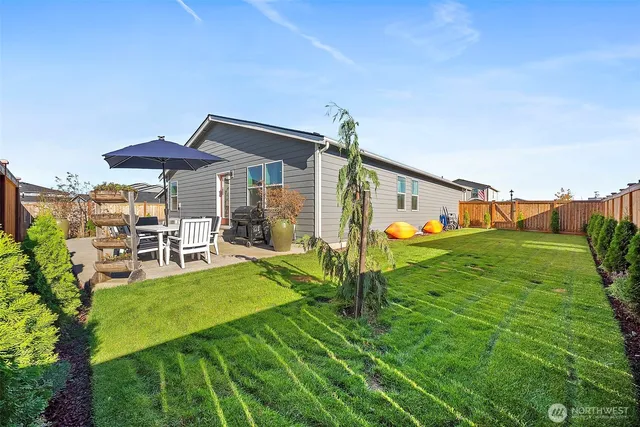 a view of a house with backyard porch and sitting area