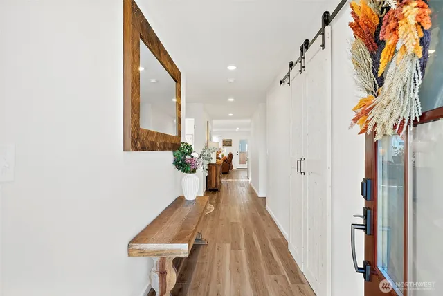 a view of a hallway with wooden floor and staircase