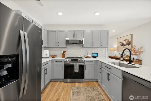 a kitchen with a stove sink and refrigerator