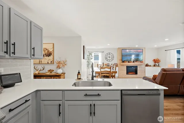 a kitchen with stainless steel appliances white cabinets and a sink