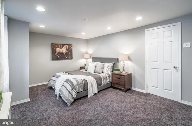 a spacious bedroom with a bed and a painting