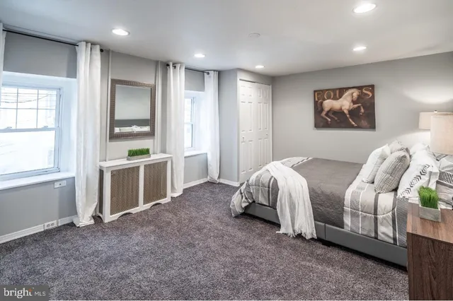 a spacious bedroom with a bed and a cabinets