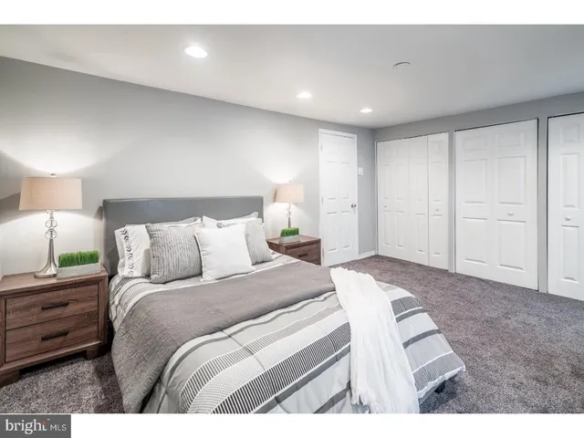 a bed room with a bed and a night stand