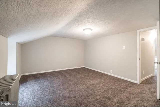 an empty room with a empty space and windows