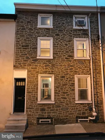 a front view of a building with brick walls