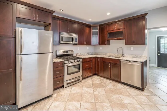 a kitchen with a sink stove and refrigerator