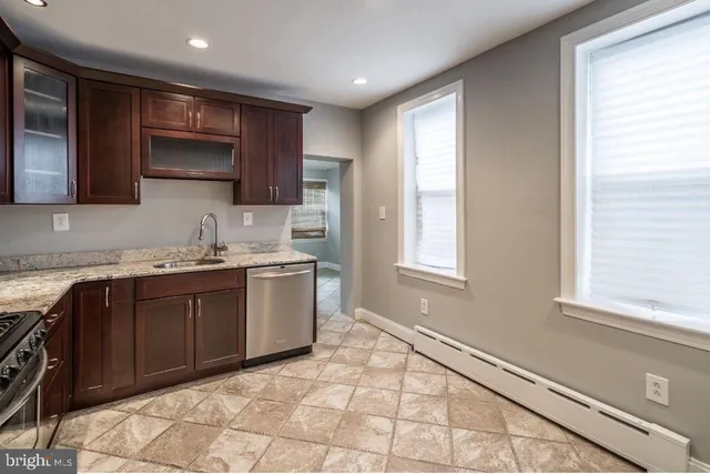 a kitchen with a sink window and cabinets