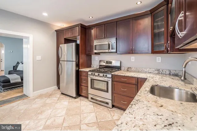 a kitchen with a refrigerator sink and stove