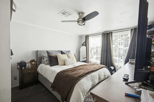 a bedroom with a bed and a chandelier