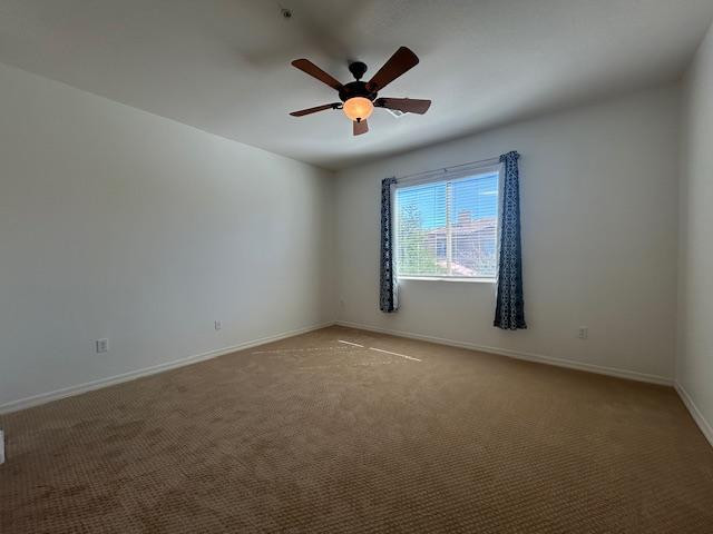 250 West Queen Creek Road, Unit 237 Chandler, AZ 85248 - Photo 9 of 18 an empty room with windows and ceiling fan