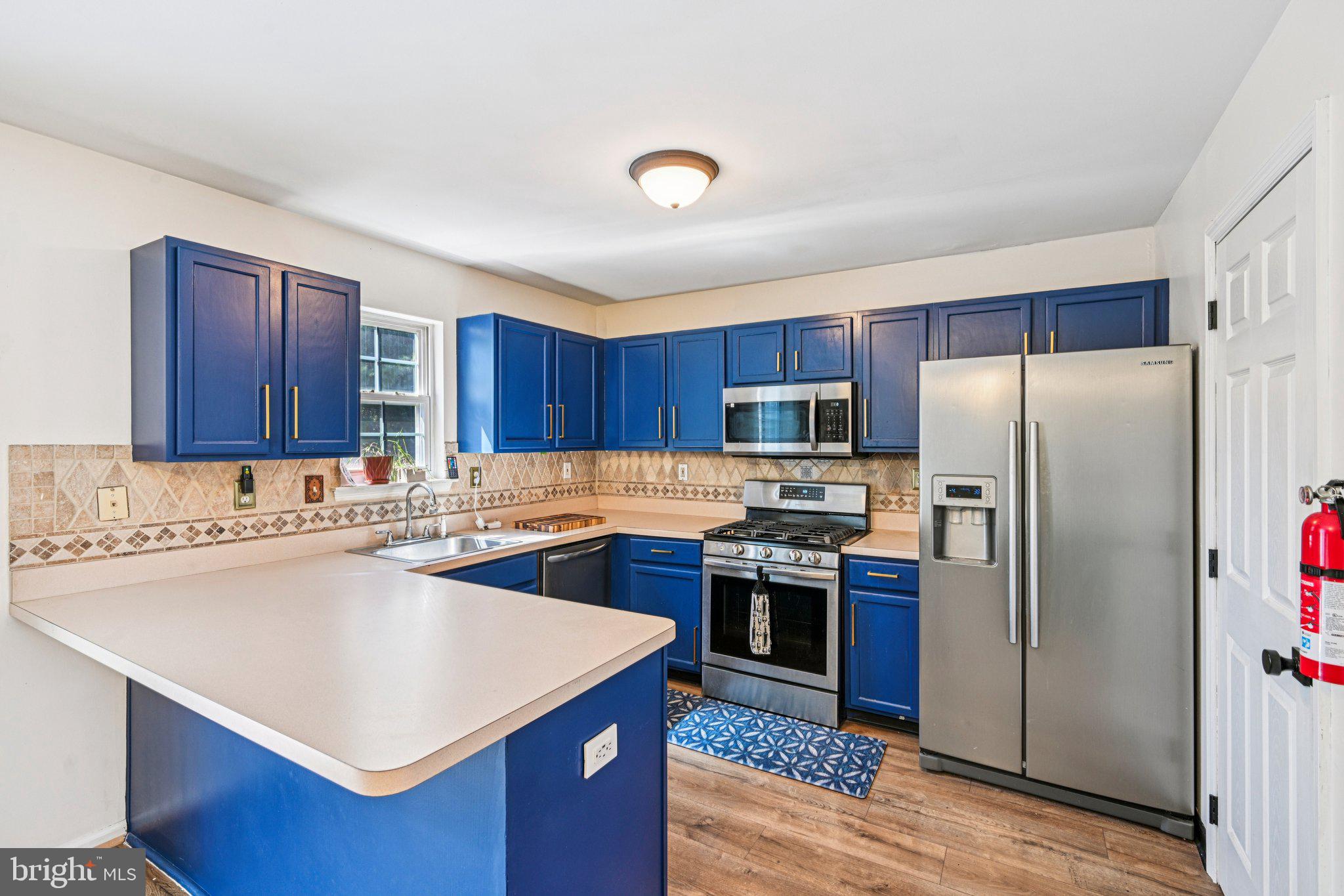 32 Millstream Road Pine Hill, NJ 08021 - Photo 12 of 36 a kitchen with stainless steel appliances a stove a sink a refrigerator and a center island