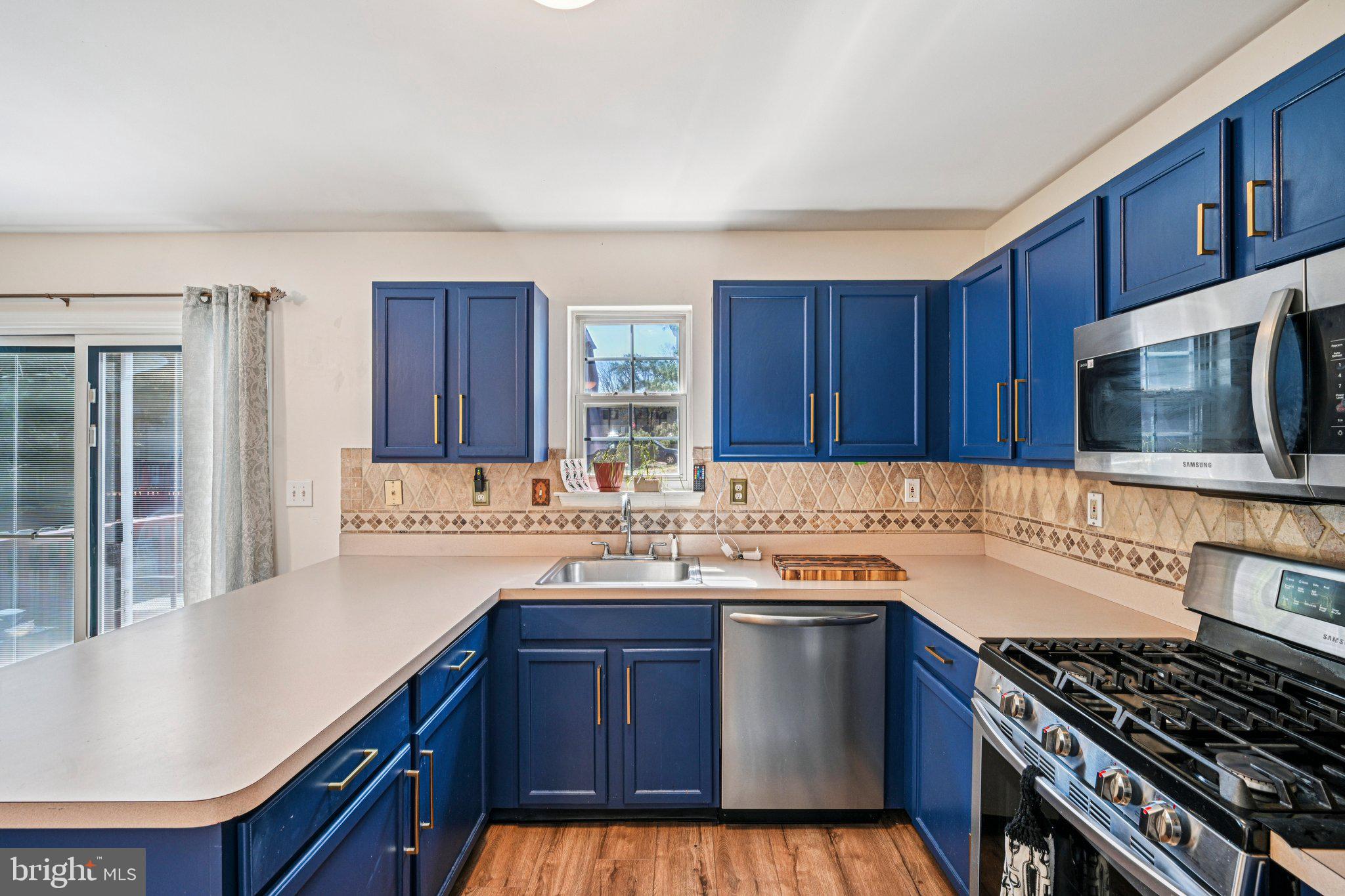 32 Millstream Road Pine Hill, NJ 08021 - Photo 14 of 36 a kitchen with a sink stove top oven and cabinets