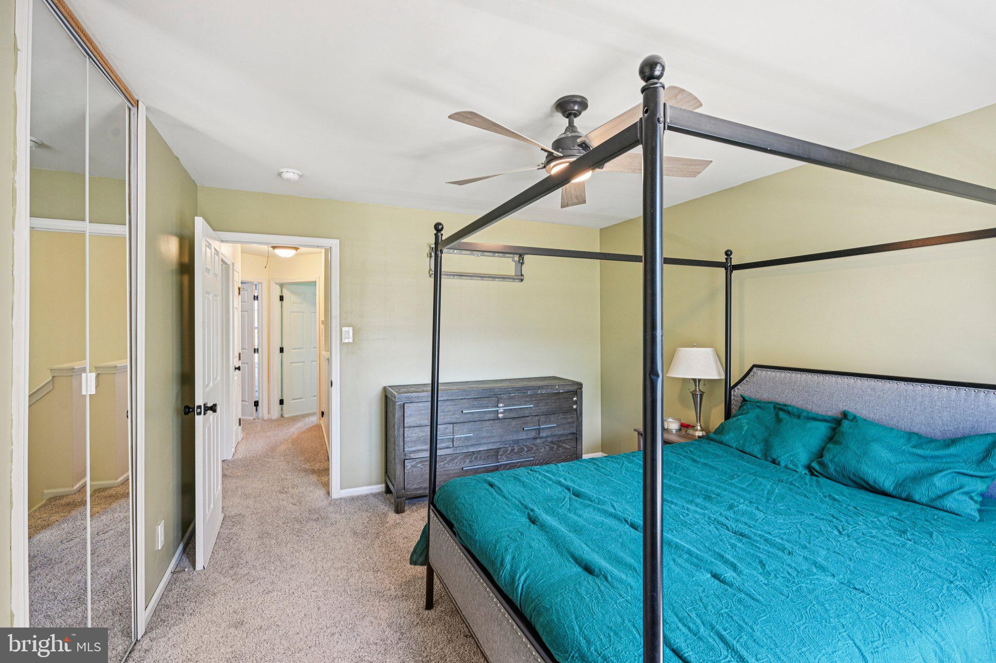 32 Millstream Road Pine Hill, NJ 08021 - Photo 18 of 36 a spacious bedroom with a bed and a chandelier