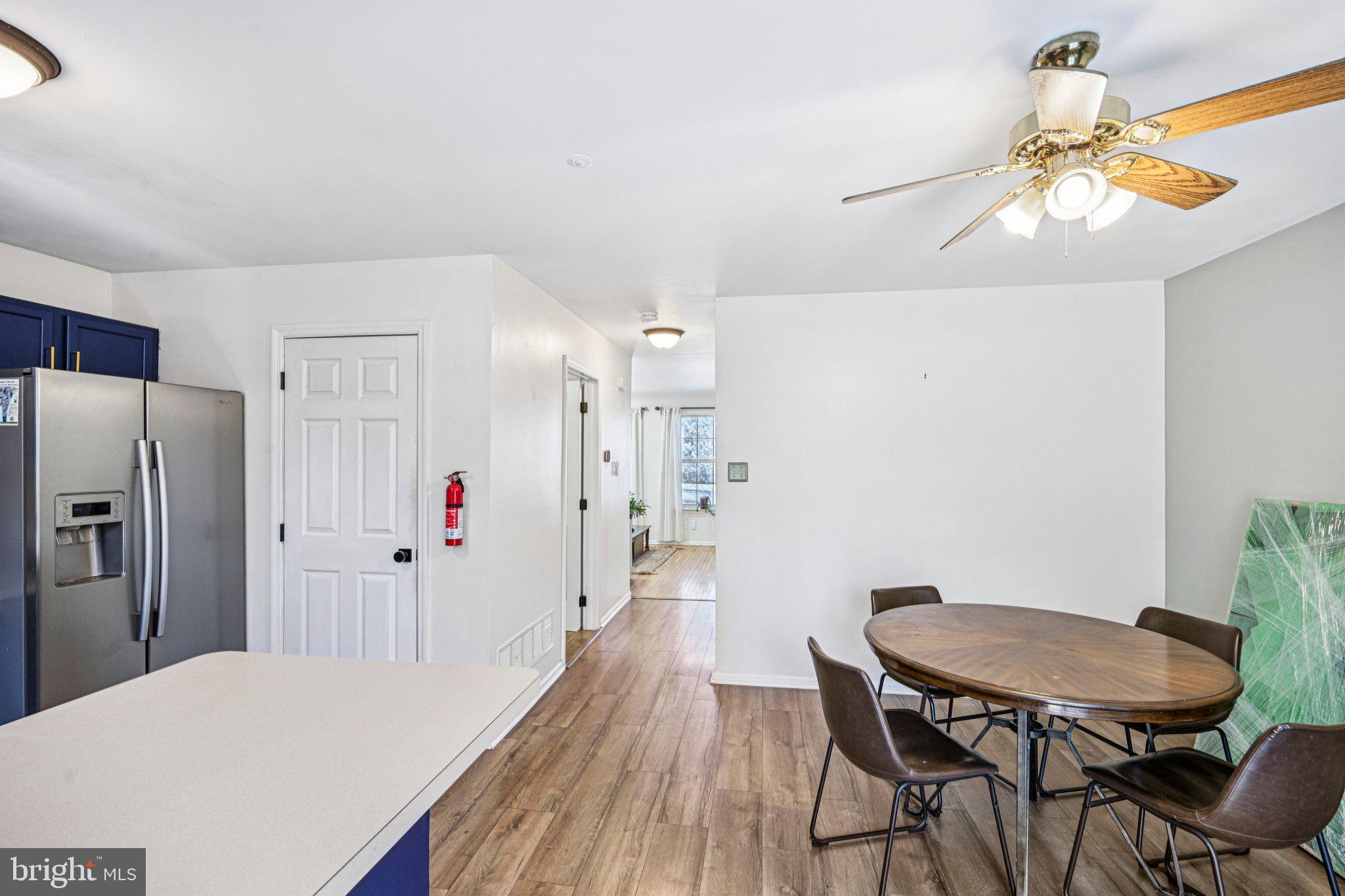 32 Millstream Road Pine Hill, NJ 08021 - Photo 10 of 36 a kitchen with stainless steel appliances a dining table chairs and wooden floor