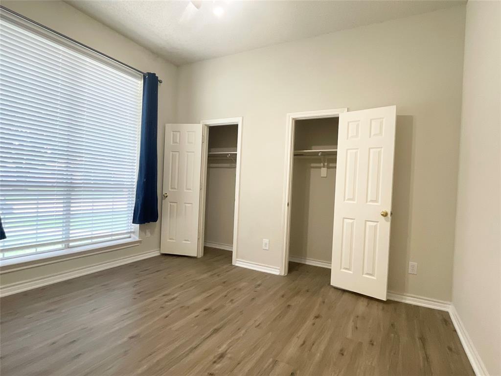6404 Meadowview Court Plano, TX 75024 - Photo 20 of 33 an empty room with wooden floor and windows
