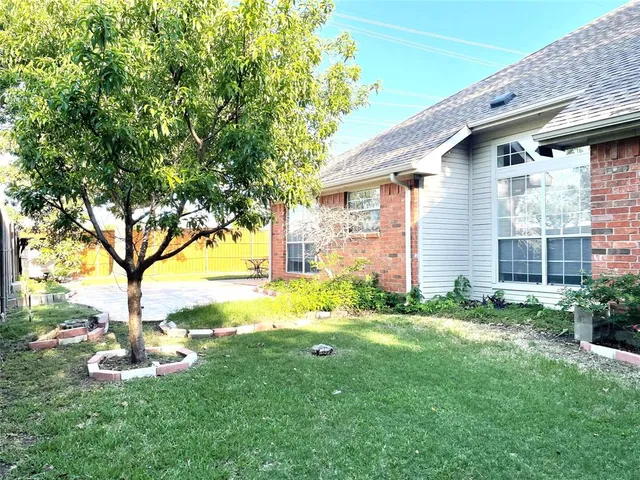 a front view of a house with yard and green space