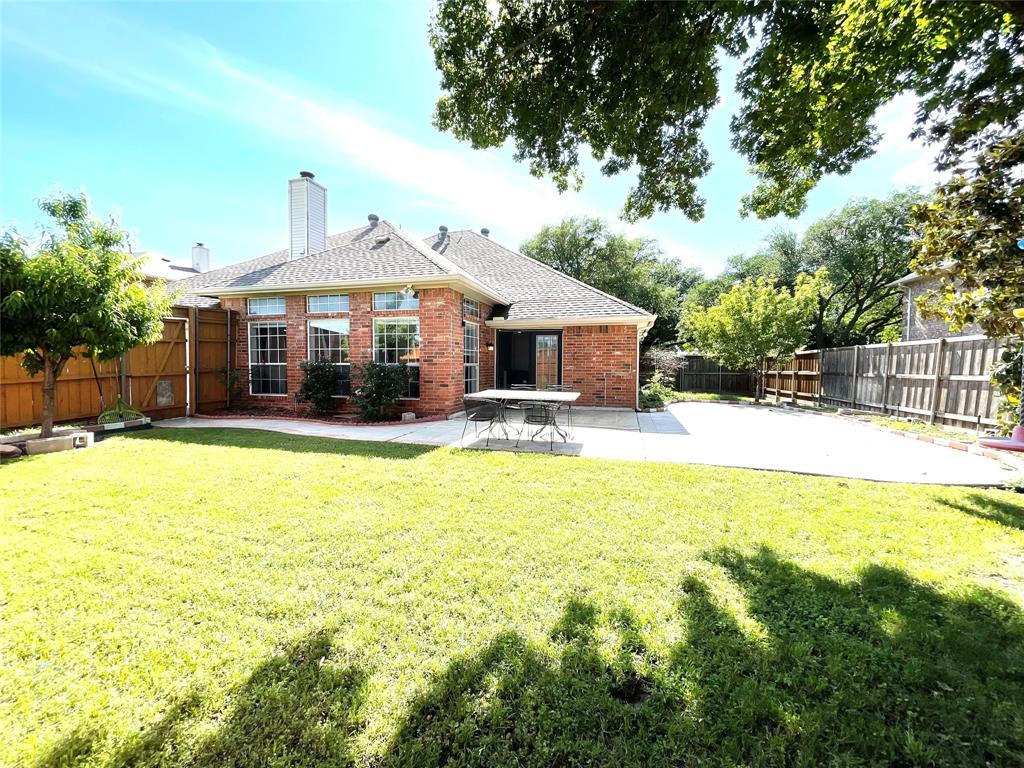 6404 Meadowview Court Plano, TX 75024 - Photo 28 of 33 a front view of a house with a yard table and chairs