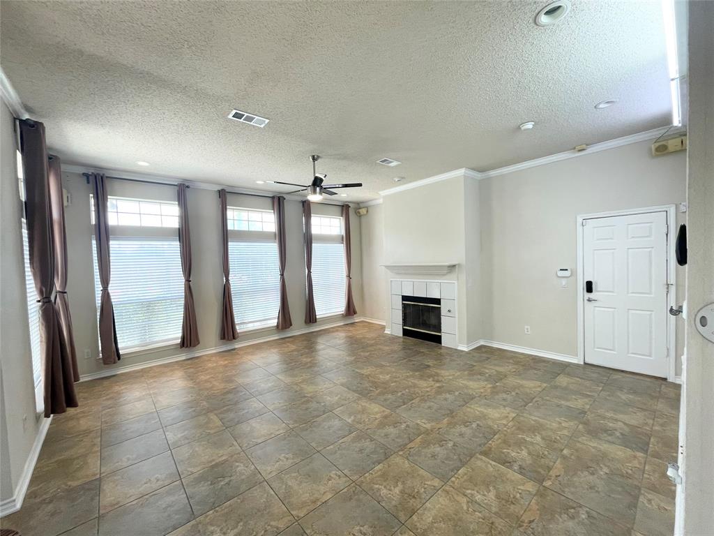 6404 Meadowview Court Plano, TX 75024 - Photo 6 of 33 an empty room with fireplace and windows