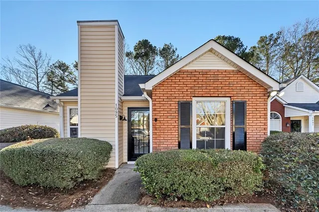 a view of a brick house with large windows