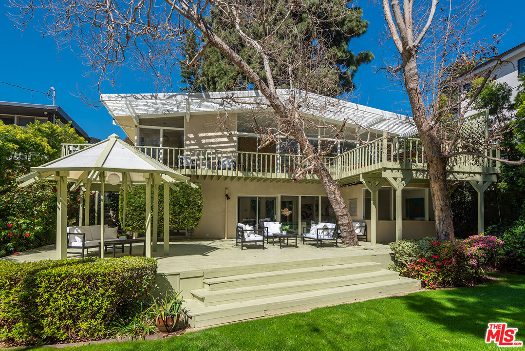 a view of a house with sitting area and garden