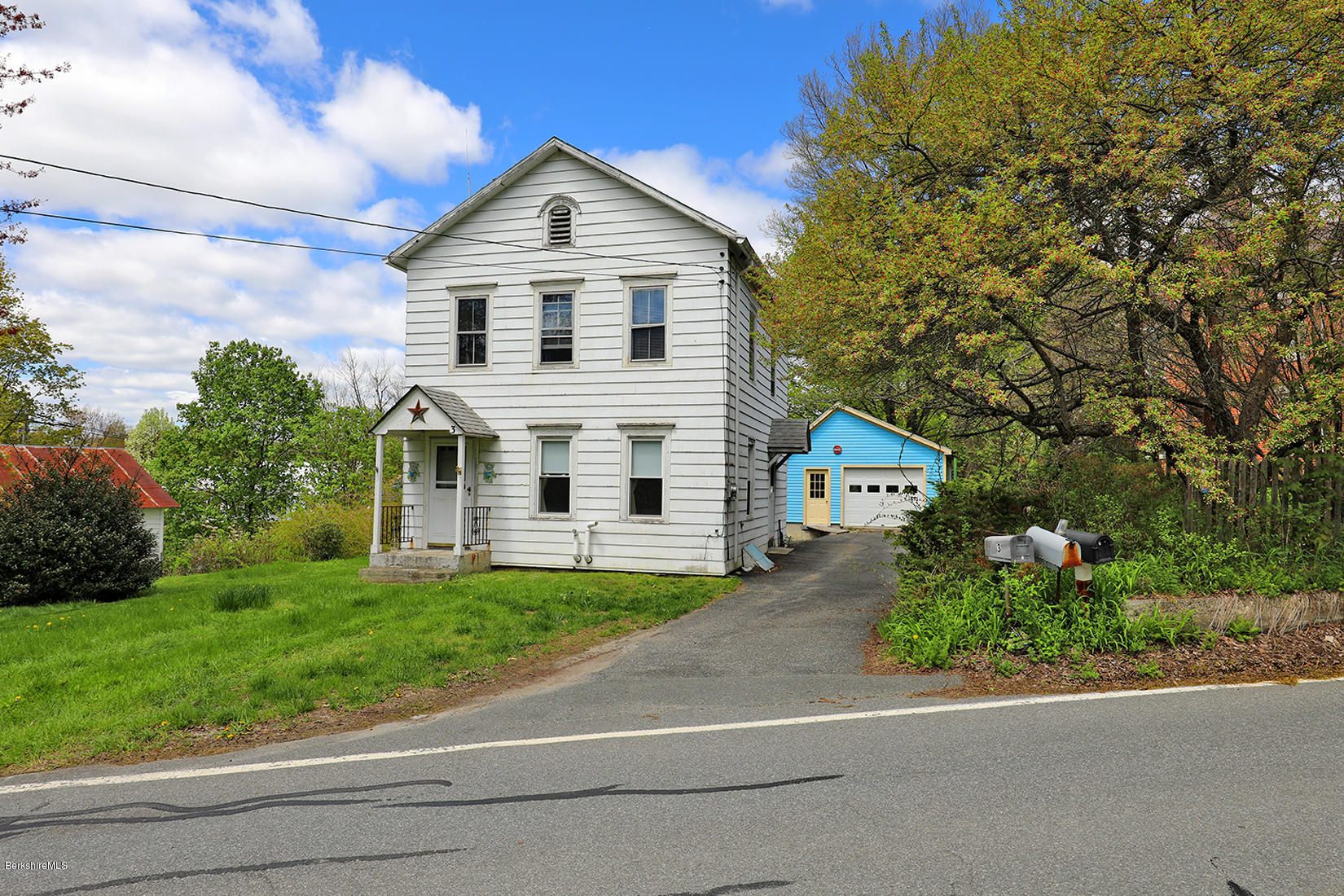 3 Lenox Road West Stockbridge, MA 01266 - Photo 20 of 20 a front view of a house with a yard and garage